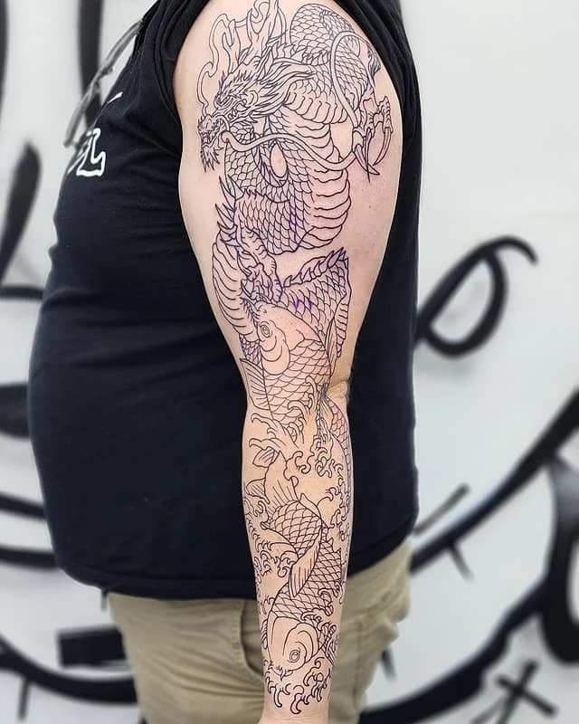 Full-sleeve tattoo of a dragon and koi fish.