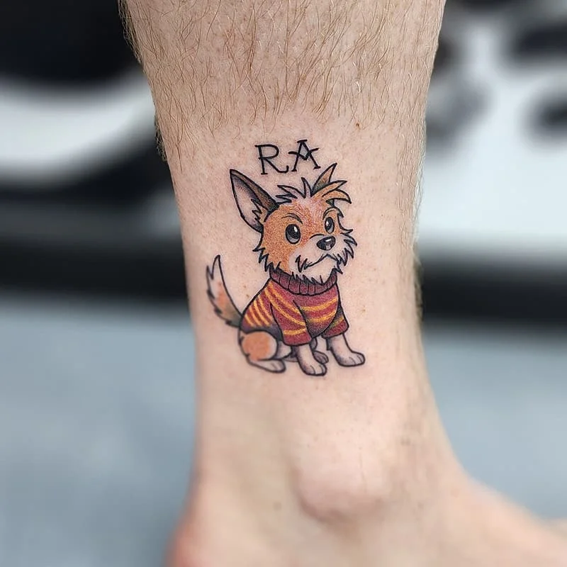 Colorful cartoon dog tattoo on ankle.