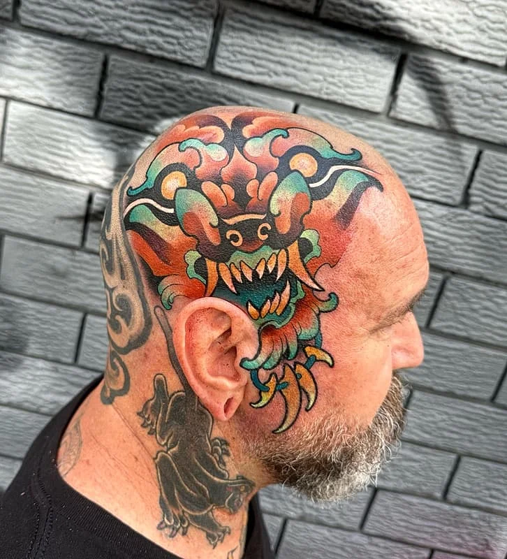 Vibrant dragon tattoo on a man's head.