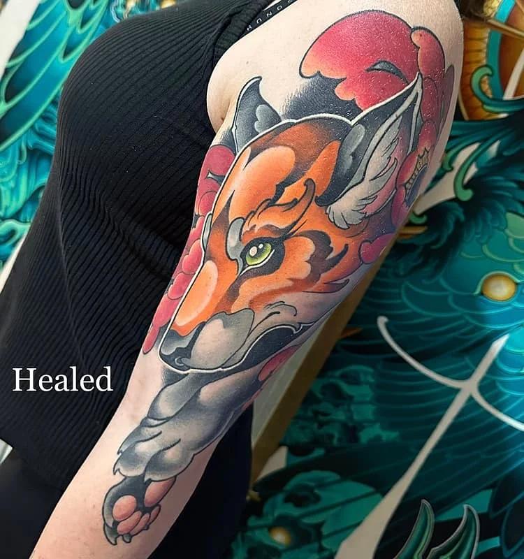 Vibrant tiger tattoo on a woman's arm.