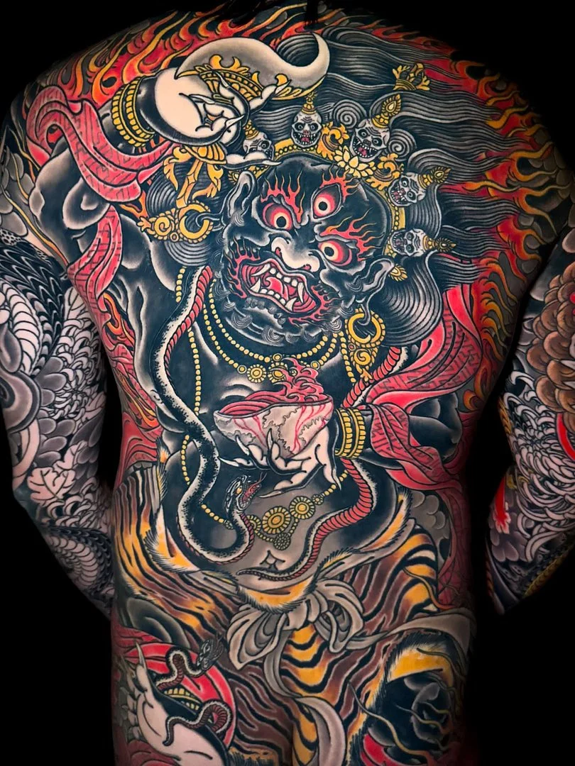 Large Japanese tattoo of a mythical demon on the back.