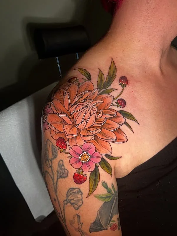 Colorful floral tattoo on shoulder and arm.