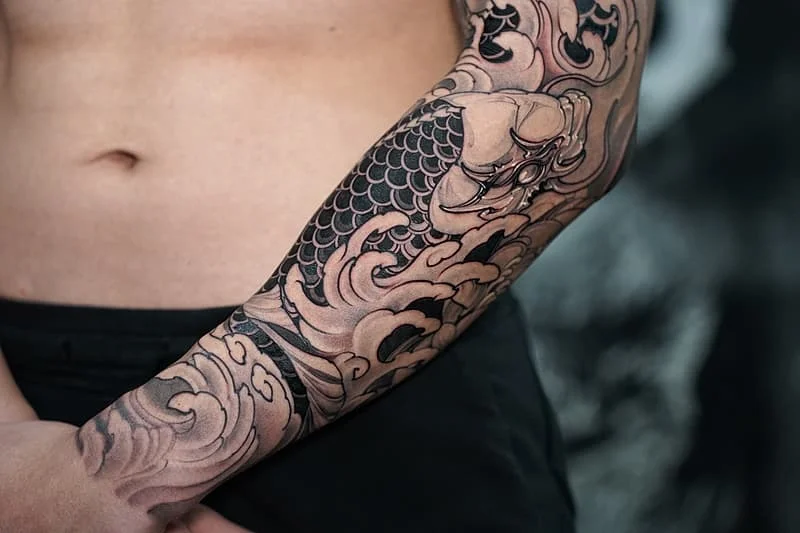 Japanese koi fish tattoo on a full arm sleeve.