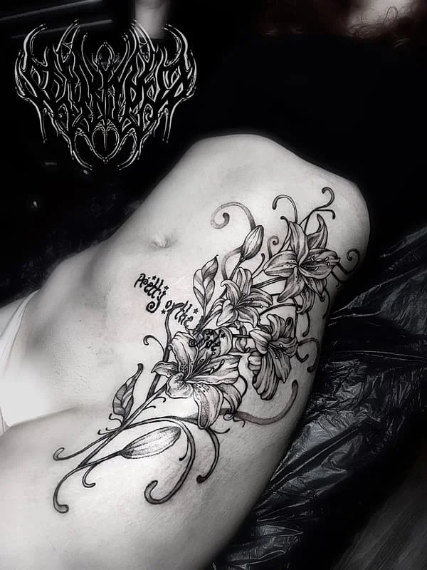 Intricate black-and-grey floral tattoo on shoulder.