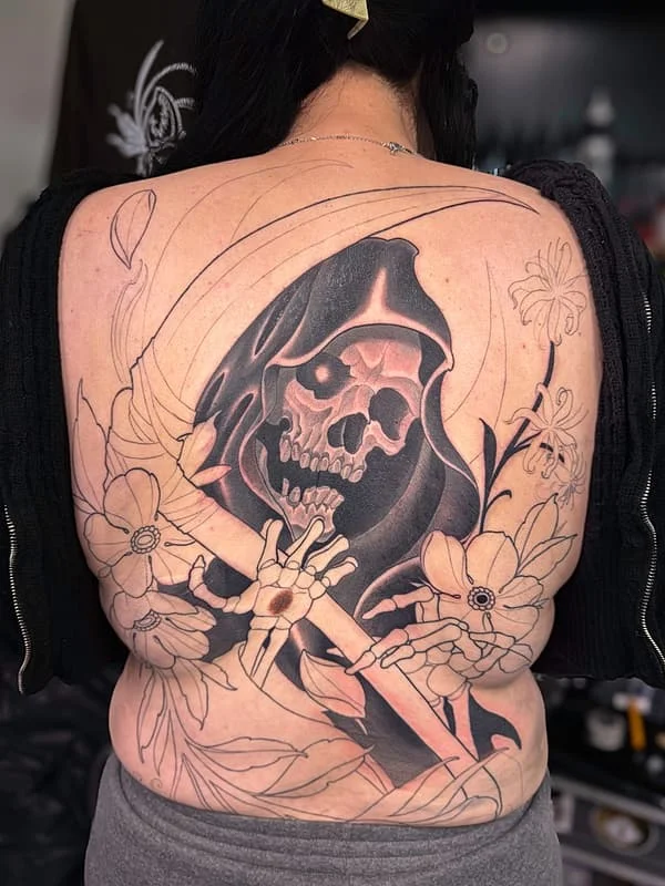 Large black-and-grey grim reaper tattoo on back.