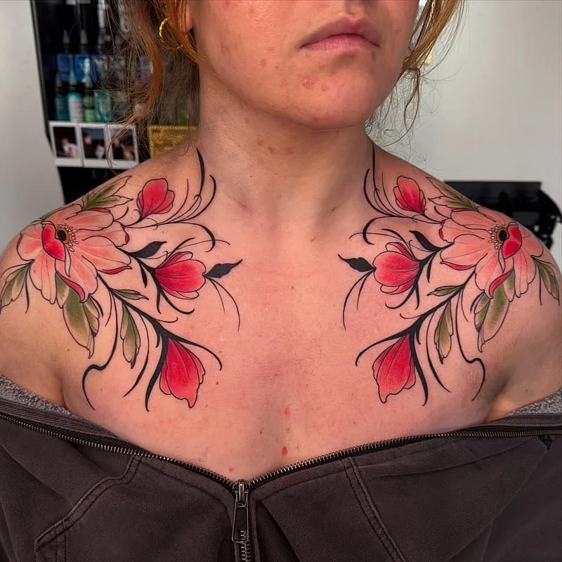 Vibrant floral tattoo on chest and shoulders.