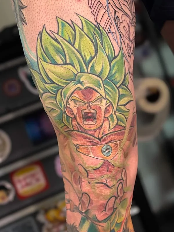 Colorful anime character tattoo on arm.