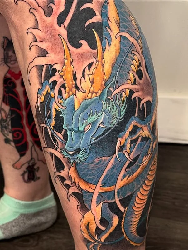 Colorful Japanese dragon tattoo on leg.