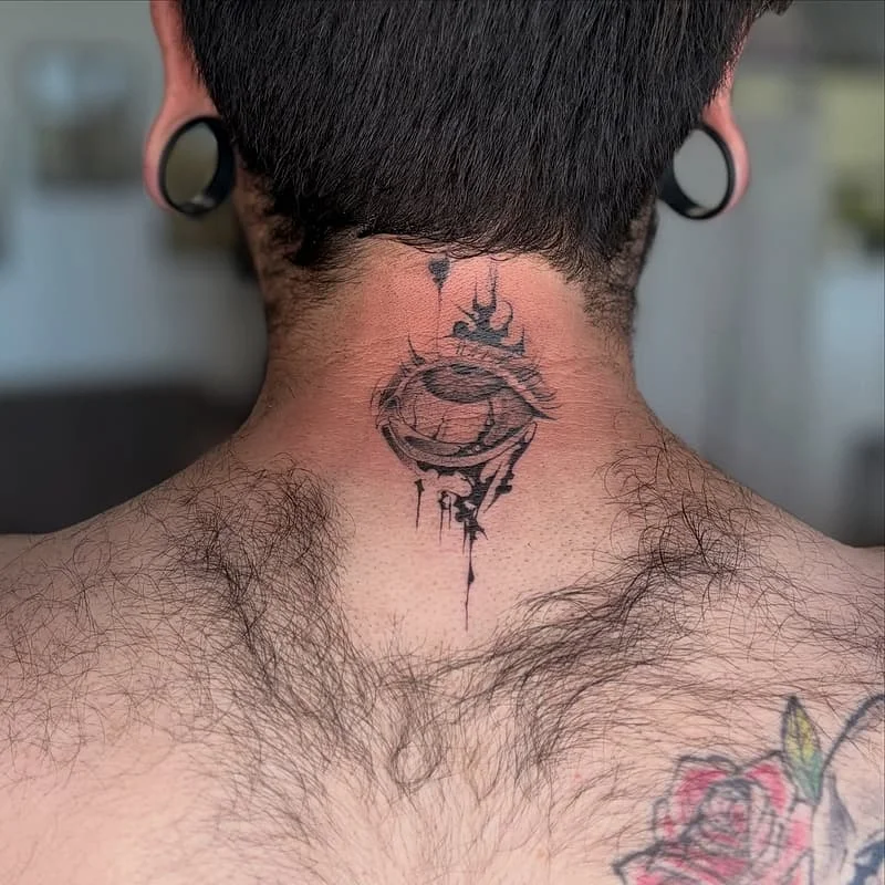Black-and-grey eye tattoo on neck.