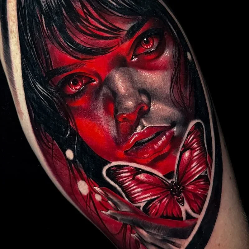 Realism illustrative tattoo of a woman with a butterfly on arm