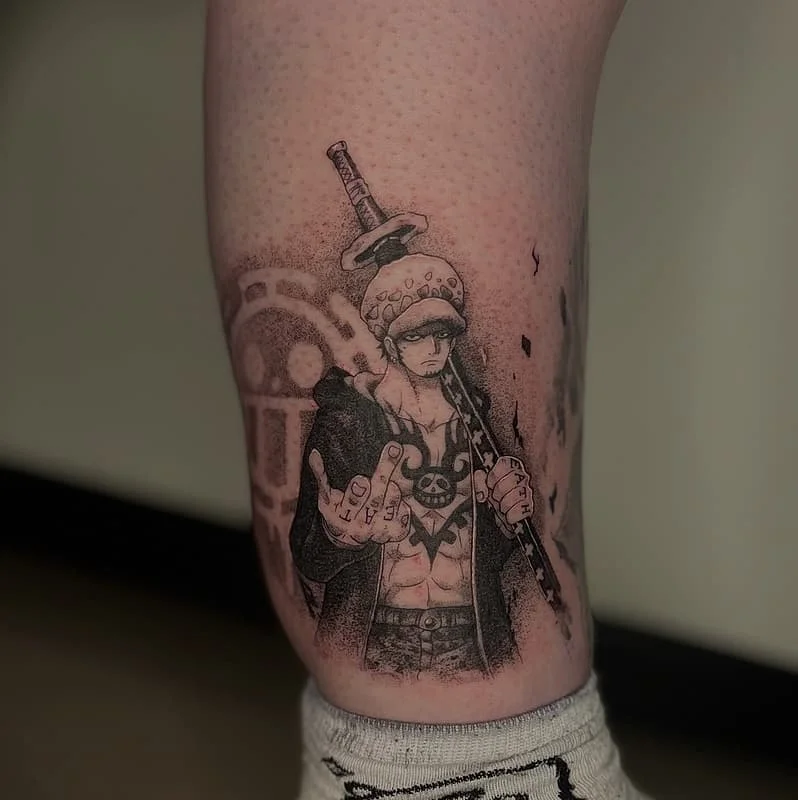 Black-and-grey anime character tattoo on leg.