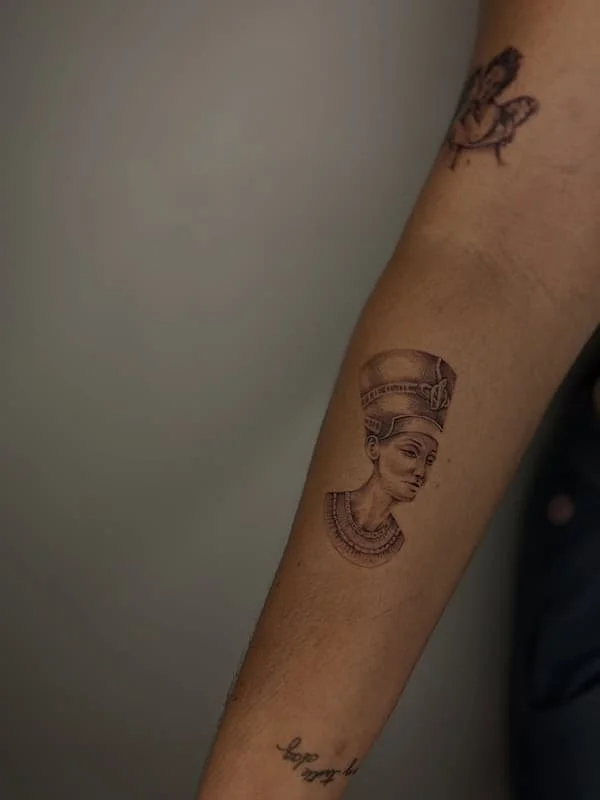 Realism tattoo of a historical figure on forearm.