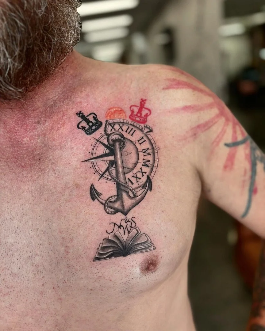 Illustrative tattoo of an anchor, clock, and book on chest.