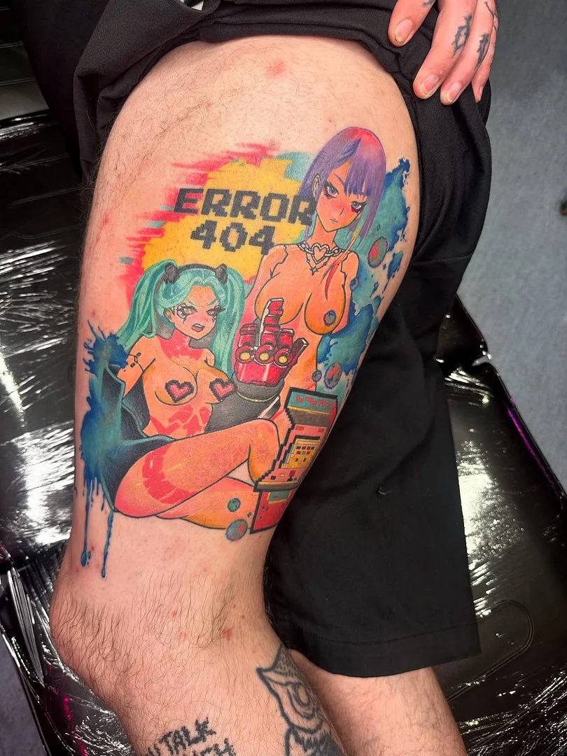 Colorful thigh tattoo featuring anime girls and error code.