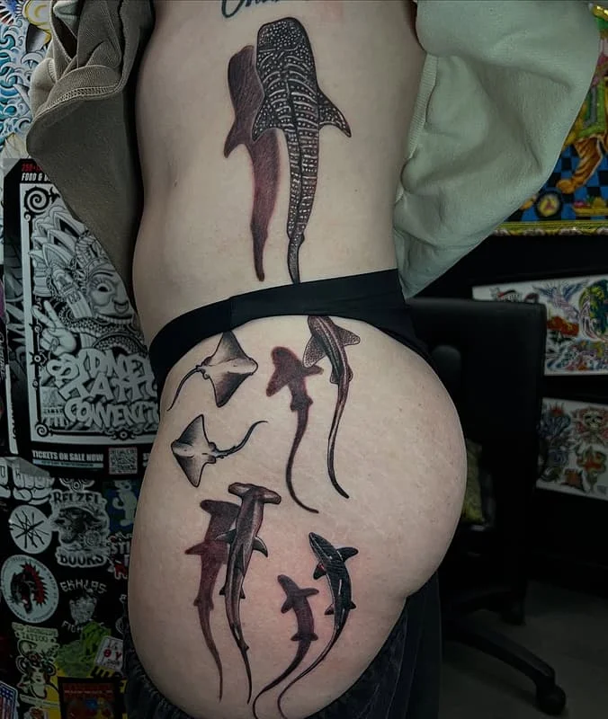 Large blackwork shark tattoo on hip and thigh.
