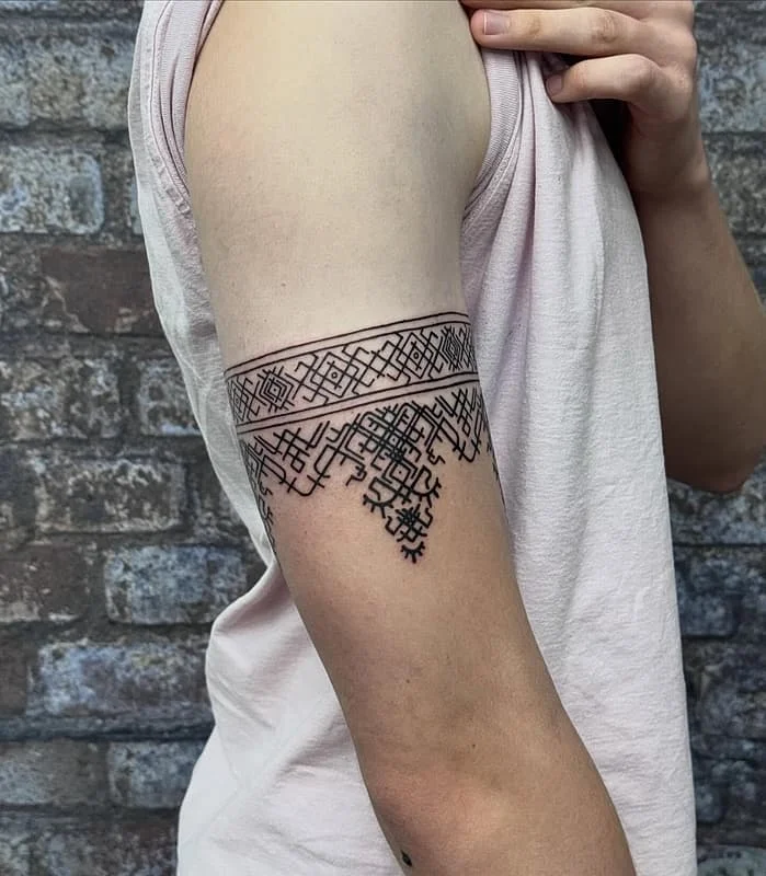 Geometric blackwork tattoo on the arm.