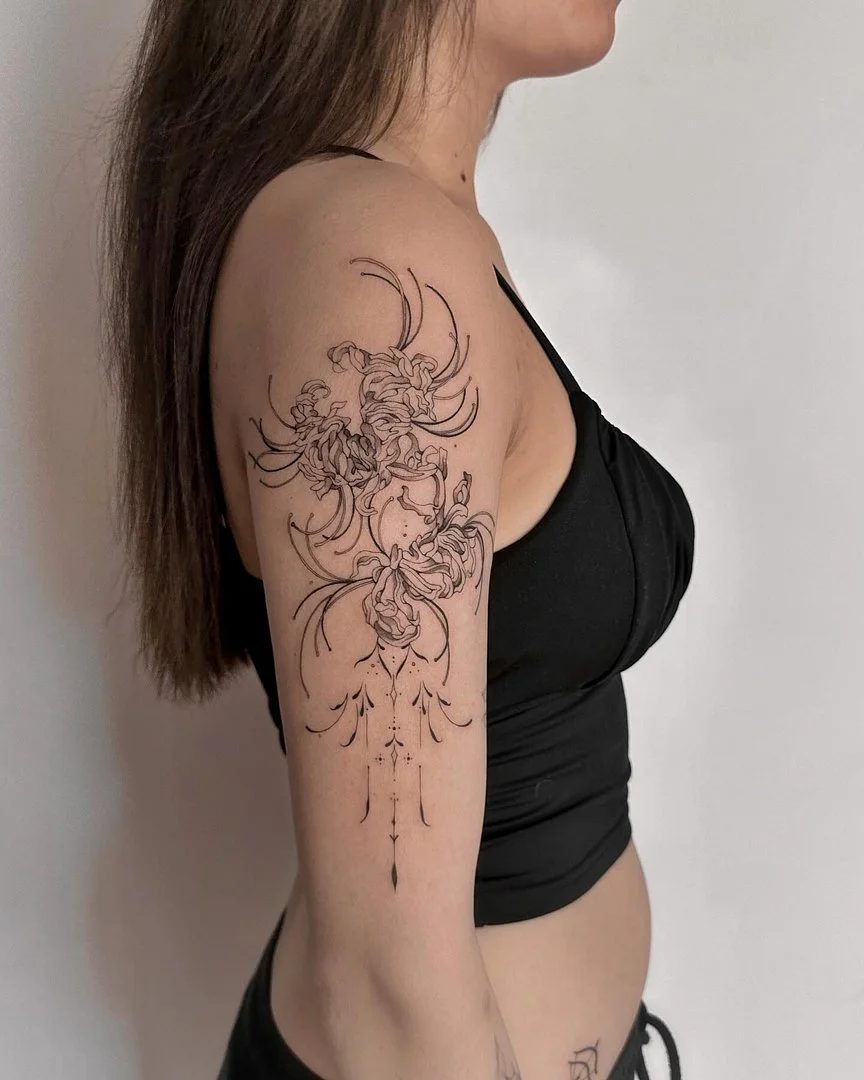 Medium-sized illustrative floral tattoo on arm.