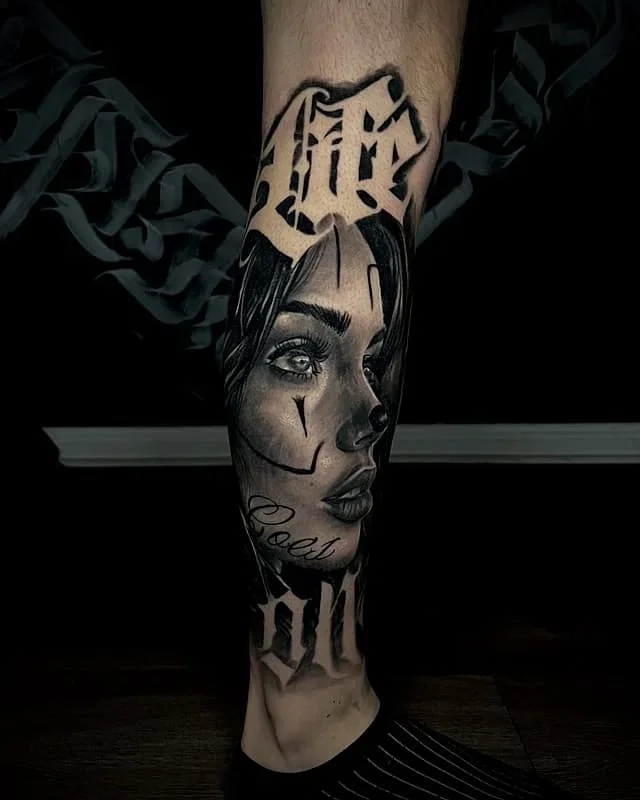 Detailed black-and-grey portrait tattoo on leg
