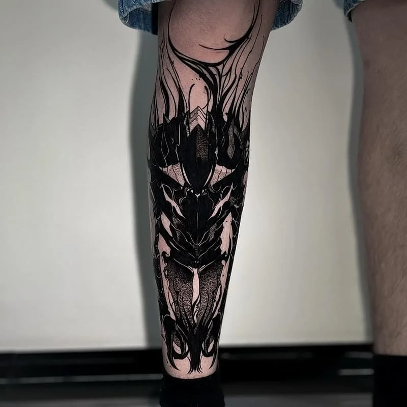 Large blackwork abstract tattoo on calf.